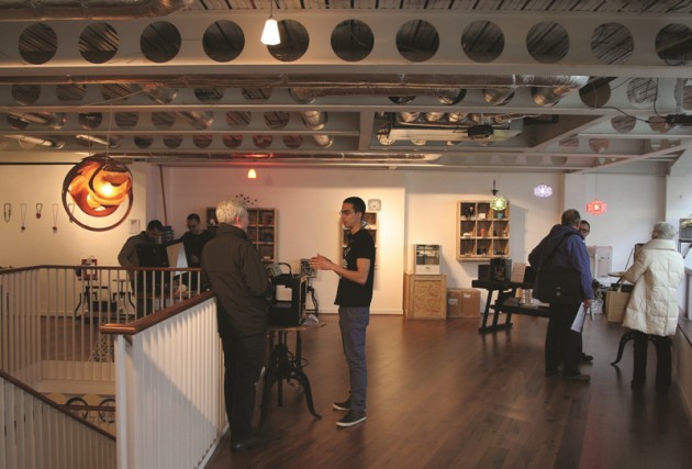 People browsing the gallery of products at the iMakr store.