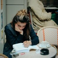 woman in black jacket sitting on chair