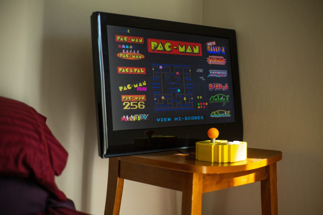 black flat screen tv on brown wooden table