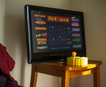black flat screen tv on brown wooden table