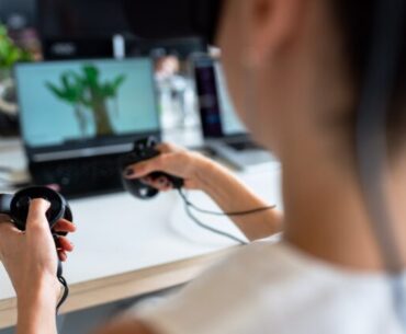 person holding black game controller
