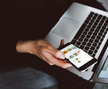 Level Up Your Digital Marketing Journey With These Tips person holding smartphone and laptop