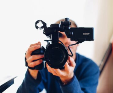 Animated Video Production: Stages and Services person holding DSLR camera