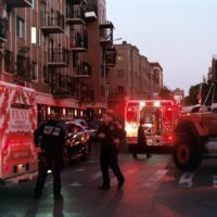 people walking on street near red and white bus during daytime