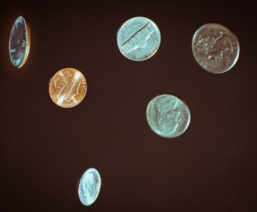 silver round coins on white surface