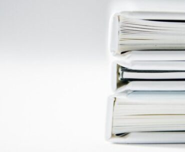 What Can You Achieve with Proper Document Formatting and Design? A stack of thick folders on a white surface