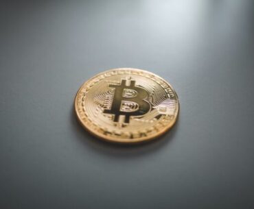 Why Is Bitcoin a Popular Cryptocurrency? gold round coin on gray surface