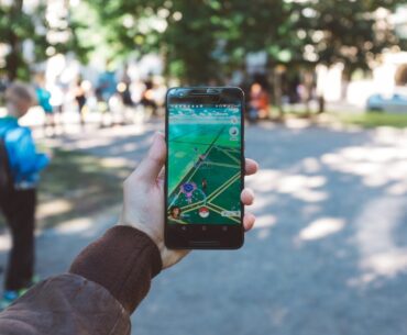 person playing Pokemon Go during daytime