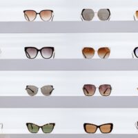 black framed sunglasses on white surface