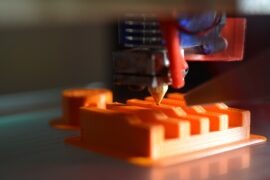 Cybersecurity threats to consider when 3D printing a close up of an orange object with a pencil