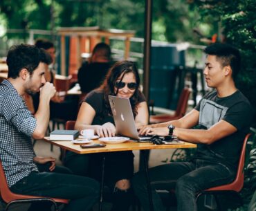 Navigating Growth: Startups and the Transformative Impact of Custom Software Solutions photo of three person sitting and talking