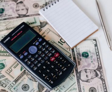 Ways to Pay Off Your Mortgage Early and Safely Ease into Retirement From above electronic calculator and notepad placed over United States dollar bills together with metallic pen for budget planning and calculation