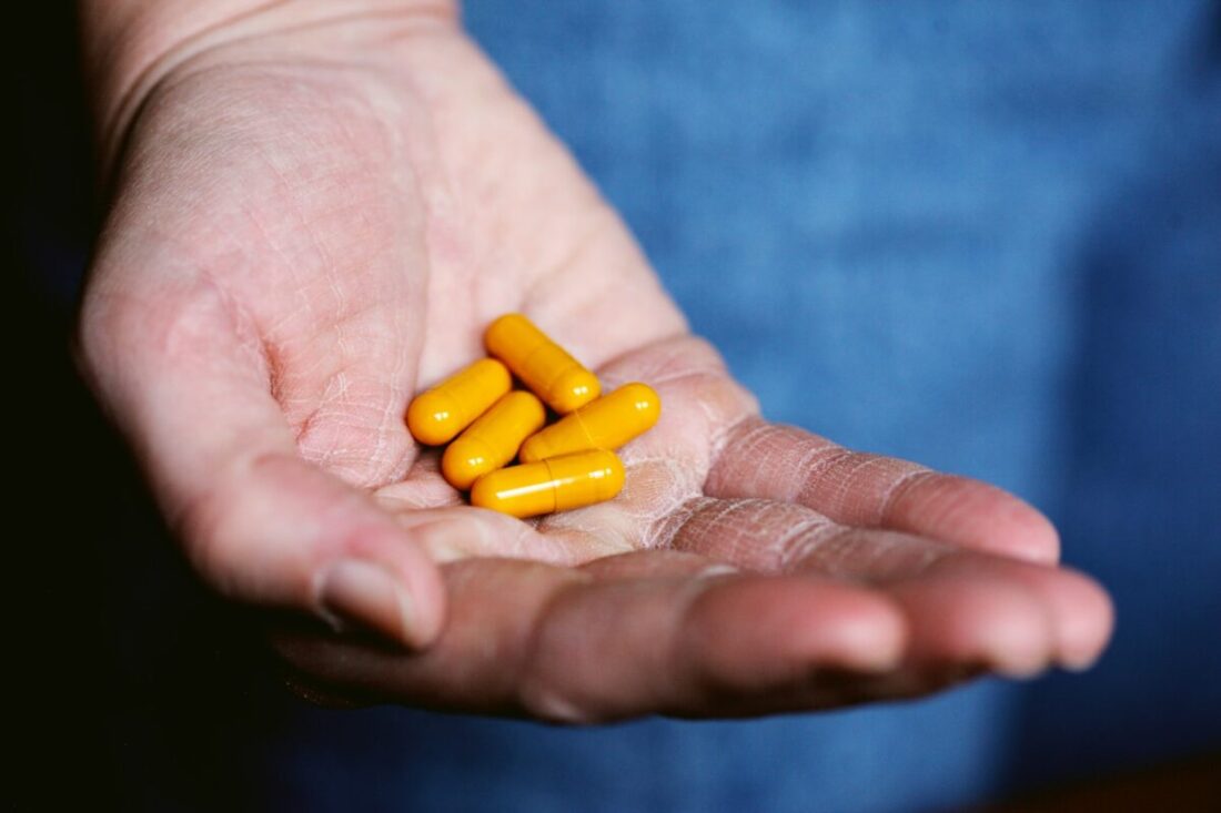 Exploring Herbal Supplements as a CBD Alternative yellow medication pill on persons hand