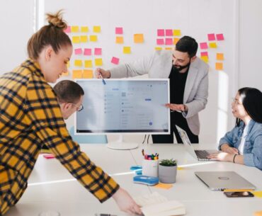 How To Choose the Best Proposal Software for Your Company man standing behind flat screen computer monitor