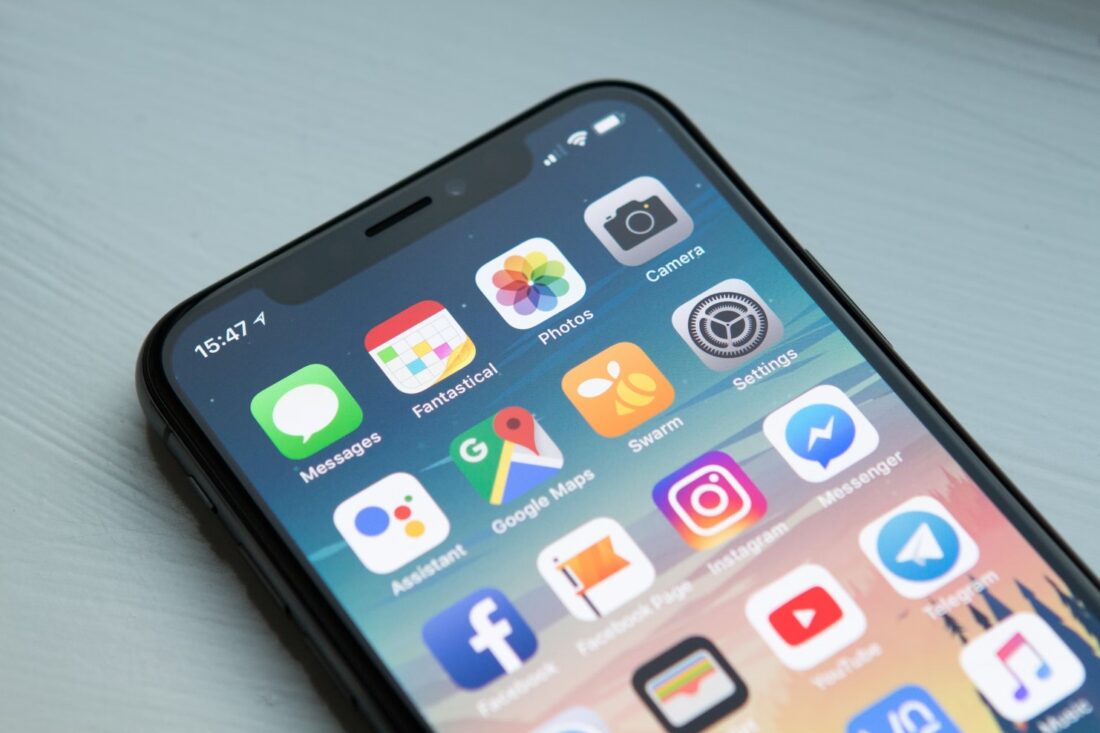 A cell phone with apps on the screen Description automatically generated