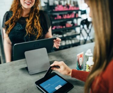 Tips to Making the Product that Your Customers Will Buy woman holding magnetic card