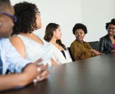 The Role of Knowledge Management Systems in Improving Organizational Performance a group of people sitting around a table