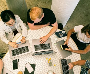 Safeguarding Cloud Prototyping: A Practical Guide for Digital Teams Top view of diverse team collaboratively working in a modern office setting.