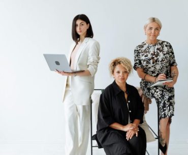 Easy Onboarding and Updates: No IT Department Required A diverse group of professional women posing confidently in a modern office setting.