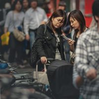 woman in black leather jacket holding microphone