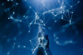 The Five Pillars of Effective AI Testing A robotic hand reaching into a digital network on a blue background, symbolizing AI technology.