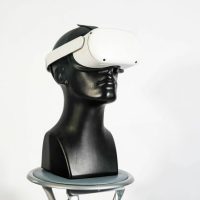 a black mannequin head with a white hat on top of it