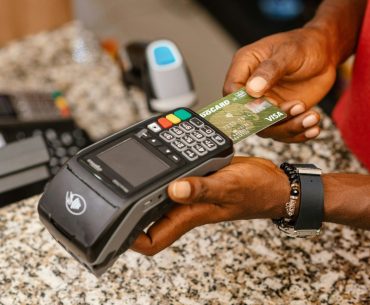 a person holding a credit card in their hand