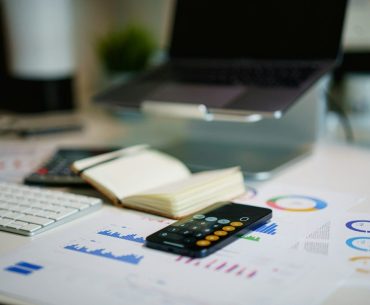 office desk with smartphone and financial charts