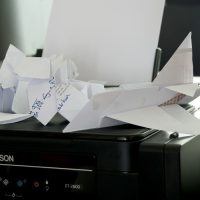 a bunch of papers sitting on top of a printer