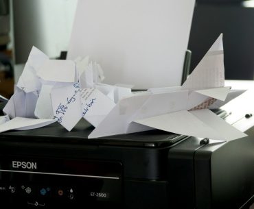 a bunch of papers sitting on top of a printer