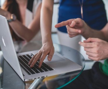 8 Best Compliance Automation Platforms Reviewed 2026 person touching and pointing MacBook Pro