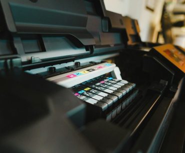 Custom Printing Trends Every Designer Should Know a close up of a printer on a table