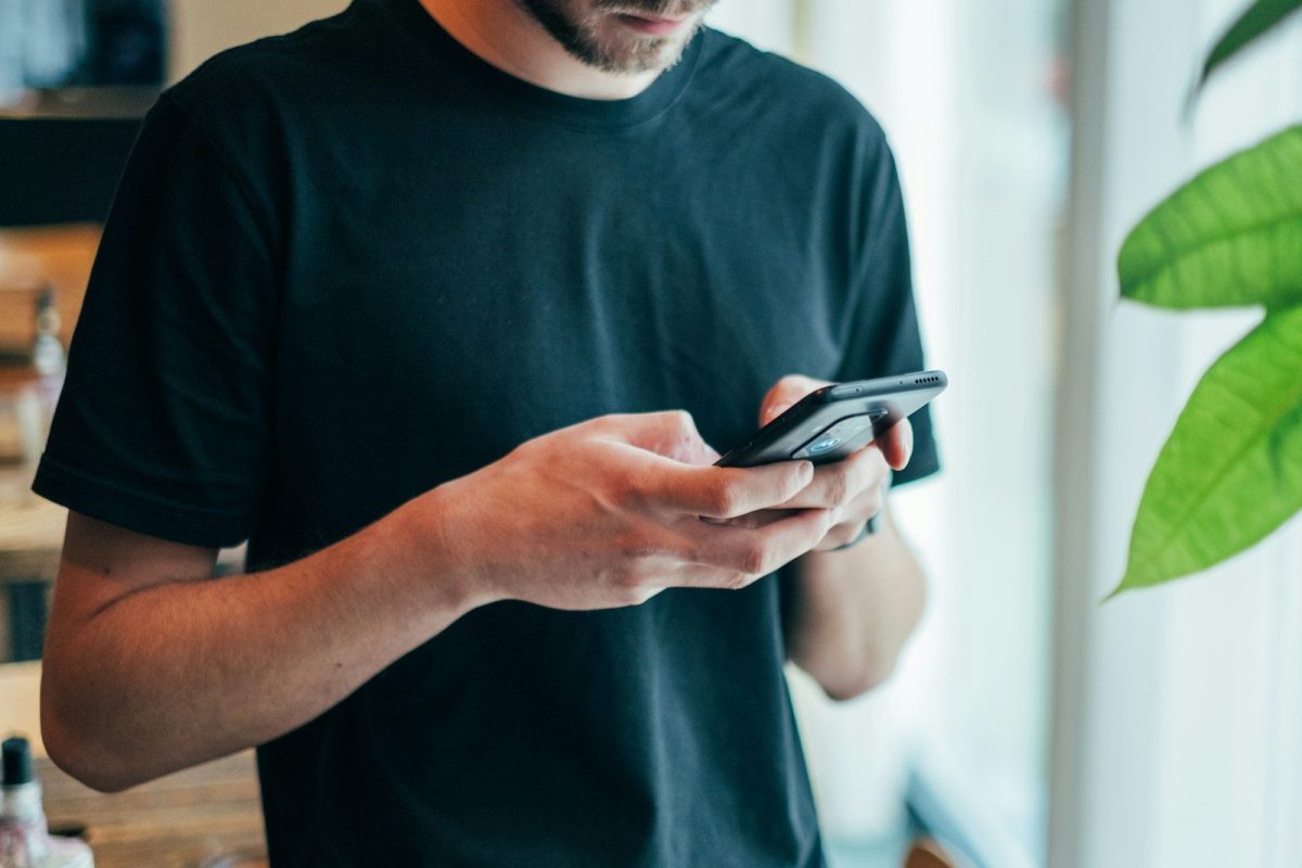 Best Crypto Casinos to Play Mines man in black crew-neck top using smartphone
