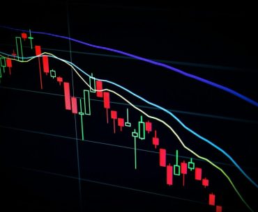 stock market candlestick chart on dark screen