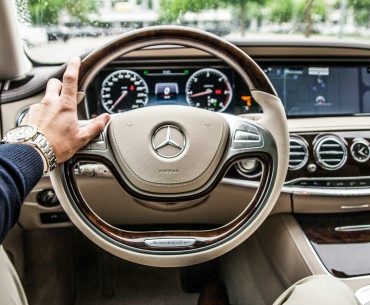 person sitting in Mercedes-Benz driver seat