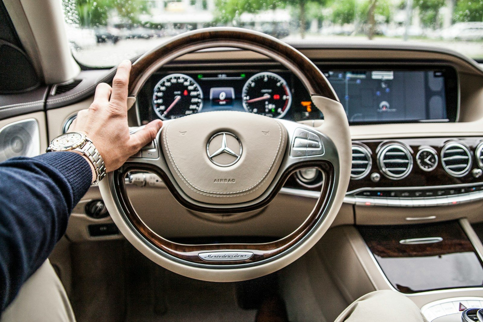 Engineering the Perfect Trip: Why Design and Manufacturing Professionals Need a Rental Car in Dubai person sitting in Mercedes-Benz driver seat