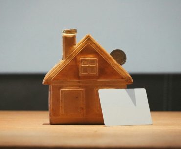 Designing a Home Workshop That Won’t Wreck Your Mortgage Appraisal A small house bank with a coin and blank card
